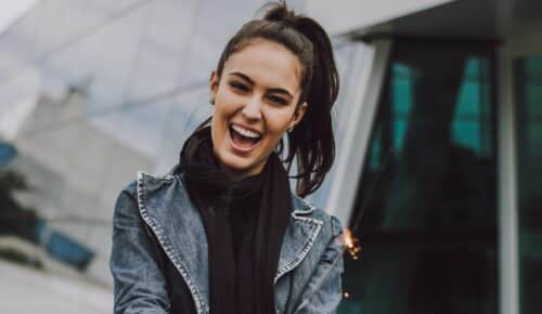 woman wearing gray denim jacket and black scarf
